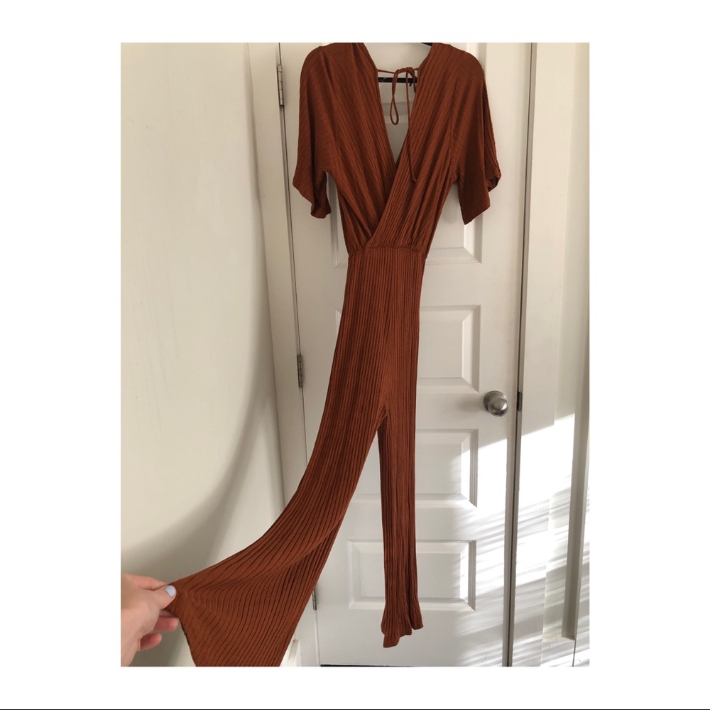 Brown ribbed knit cross-top jumpsuit.